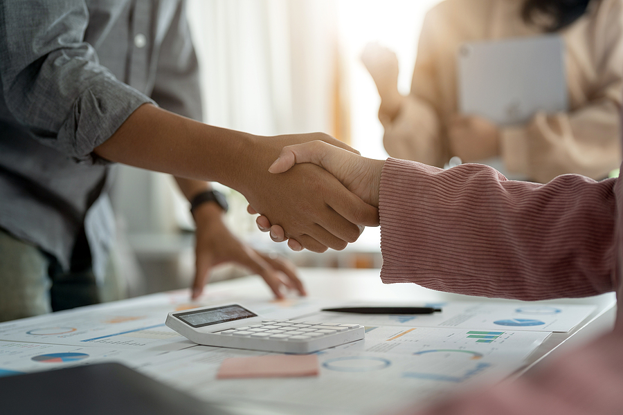 Two business people shaking hands and agreeing on a deal