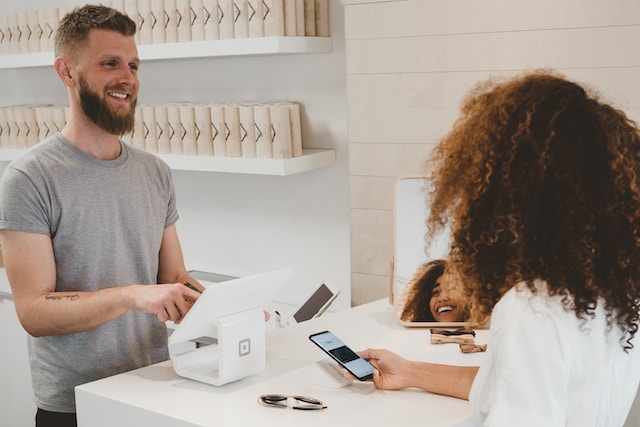 Man smiling to woman on counter 